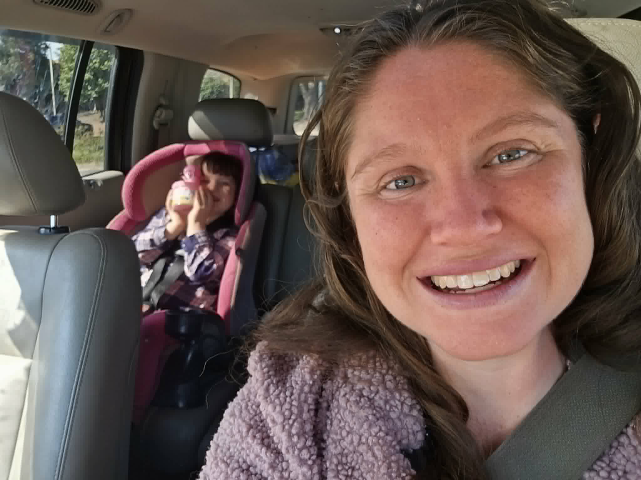 Cassandra with her child in the car